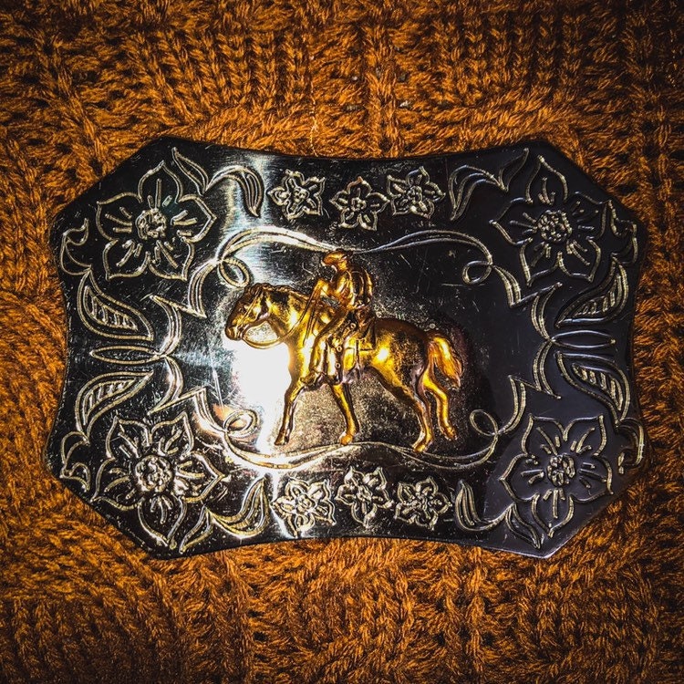 Vintage Western Sand & Sage Nickle and Silver Buckle with a Cowboy Riding a Horse and Floral Etching